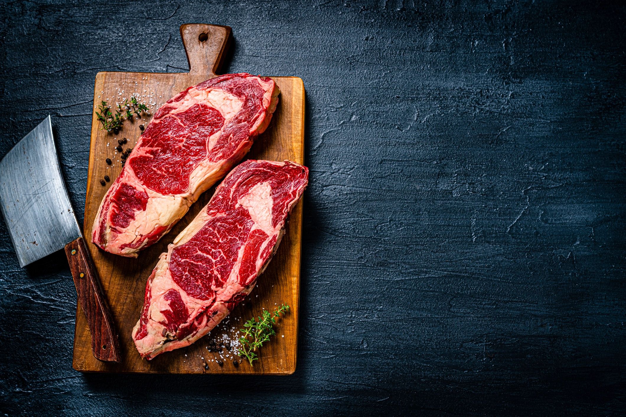 Raw beef steaks on a cutting board